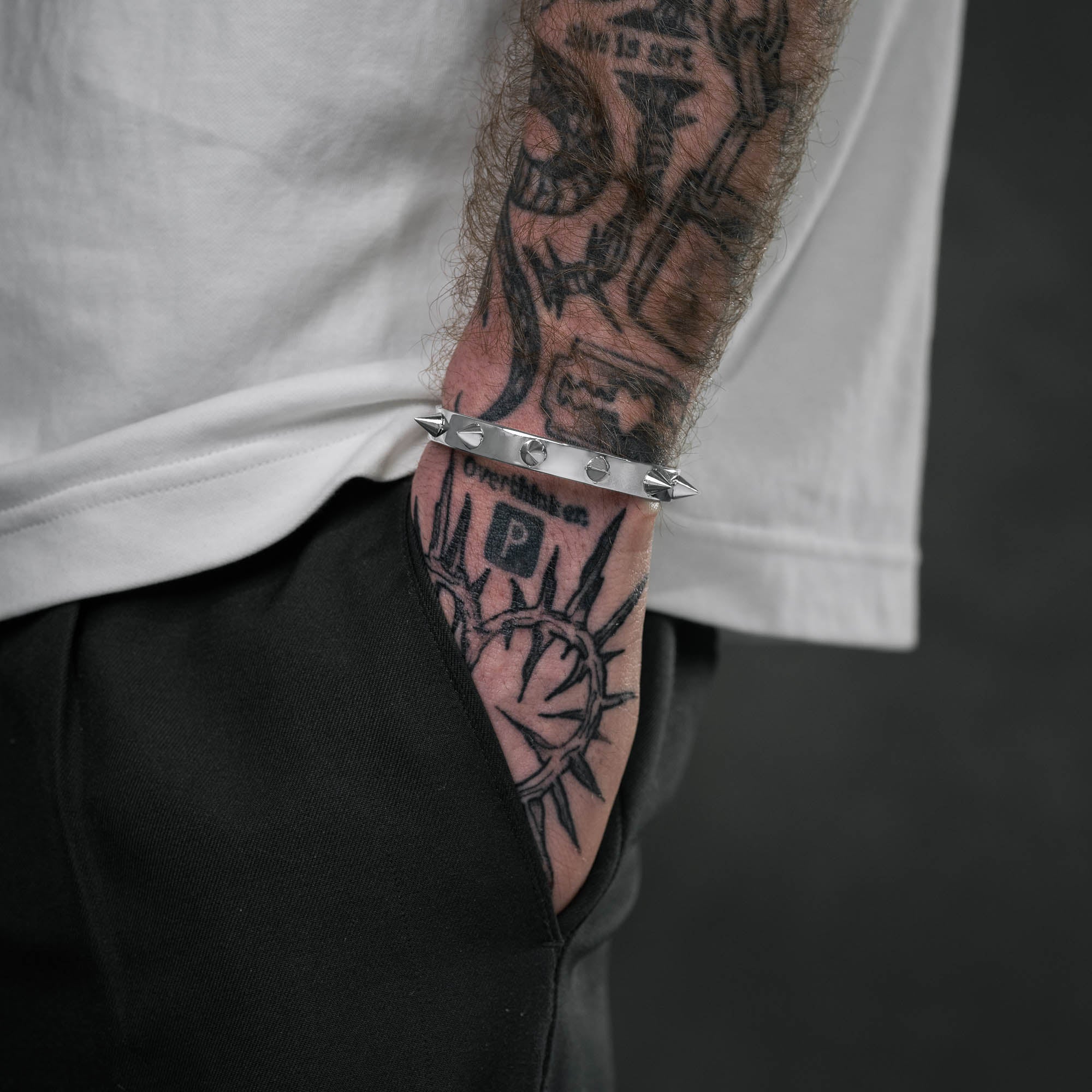 Silver Spiked Cuff bracelet with collar details on male model with tattoos