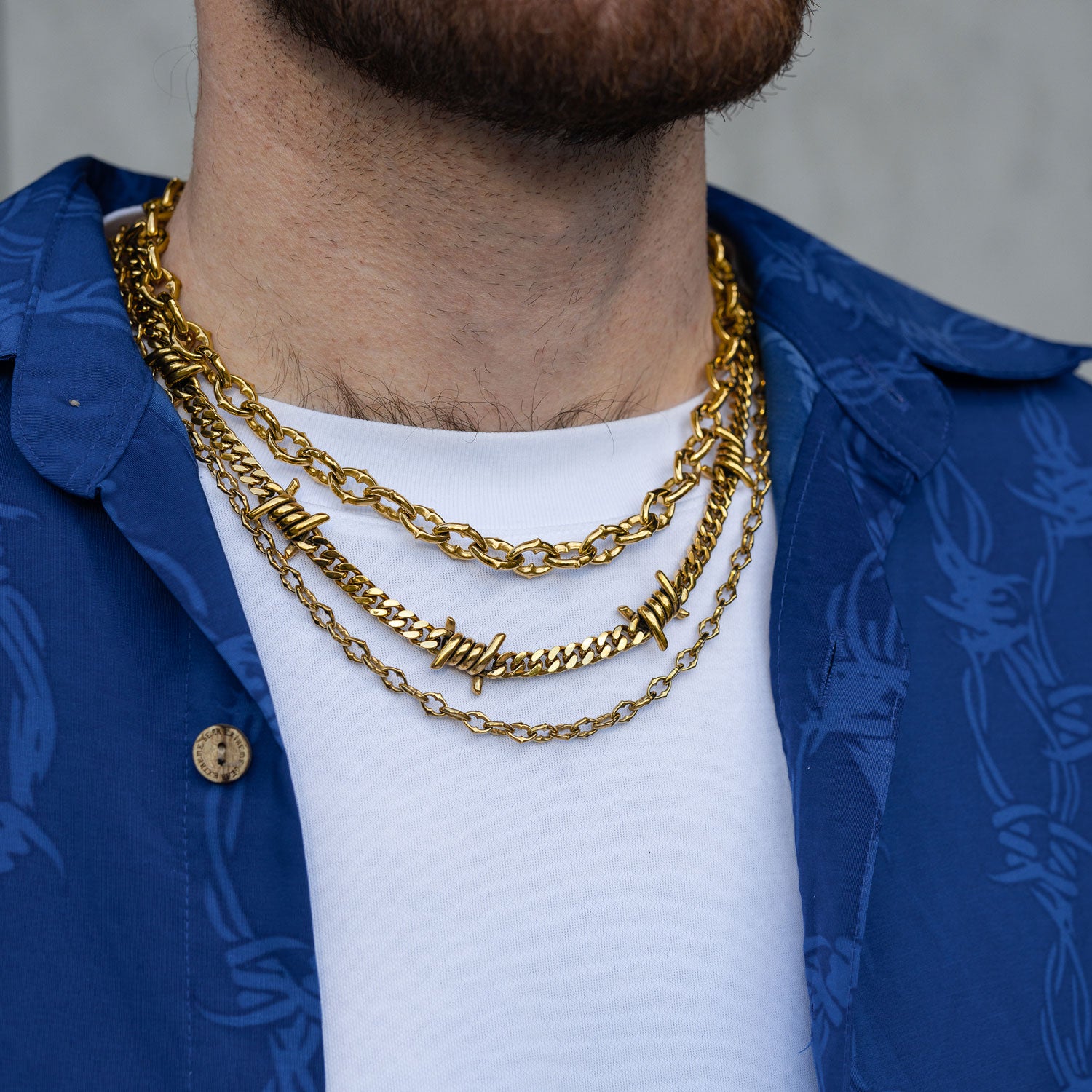 Gothic Gold chain set with spiked and barbed wire jewelry on mans neck by statement collective